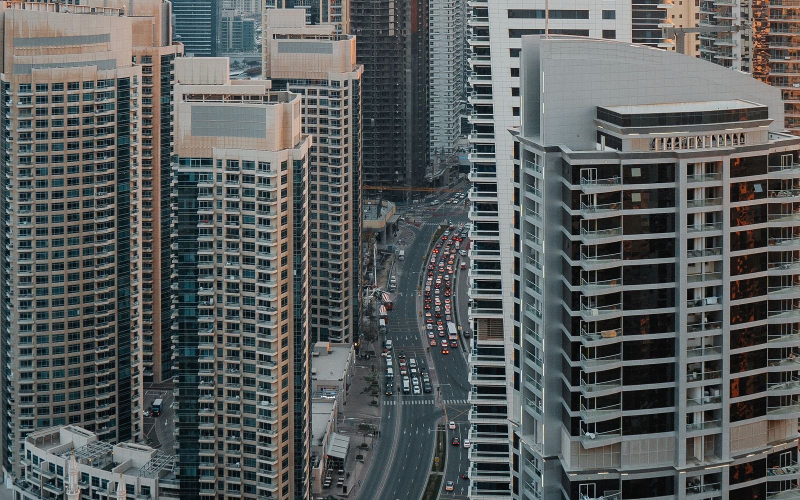 Road through a Dubai high-rise district for a guide to buying costs